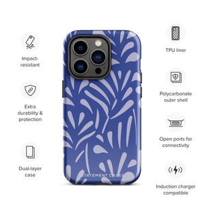 An iPhone encased in the "Mariposa Azul" by Statement Cases, featuring a blue design with an abstract white leaf pattern. The case combines curved and pointed shapes and provides dual-layer protection with TPU lining and impact-resistant polycarbonate. Camera lenses and other top elements remain unobstructed, and "Statement Cases" is inscribed at the bottom.