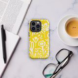 The Sol Dorado for iPhone by Statement Cases is a smartphone with a yellow case featuring a white, abstract floral and plant pattern. The camera lenses are prominent in the top left corner of the device. With dual-layer protection and impact-resistant TPU lining, "Statement Cases" is printed at the bottom of the case.