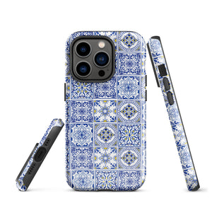 The Lisboa Azul for iPhone by Statement Cases is a smartphone adorned with a dual-layer protection phone case, featuring an intricate blue and white tile pattern. The design showcases various geometric and floral motifs, forming a visually appealing mosaic effect. The impact-resistant camera lenses and flash are prominently visible at the top left.