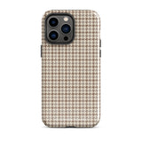 A smartphone with a brown and beige houndstooth-patterned case is shown from the back. The impact-resistant, dual-layered Classic Houndstooth for iPhone by Statement Cases protects the phone's body and leaves openings for the camera lenses and flash. The hues give the case a stylish and sophisticated appearance.