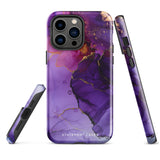 A Statement Cases Golden Orchid Marble for iPhone with a case featuring an abstract design of swirling purple, pink, and gold hues over a white background. The marbled patterns with metallic accents provide dual-layer protection and are impact-resistant. The top of the case has cutouts for the phone's camera lenses and is induction charging compatible.