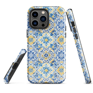 The Blue Mirage for iPhone by Statement Cases features a dual-layered, impact-resistant polycarbonate exterior with a TPU inner liner. Inspired by traditional Portuguese tiles, the blue and yellow patterned case boasts an intricate design of floral and geometric motifs. With its elegant and colorful appearance, the phone's camera is visible at the top left of the case.