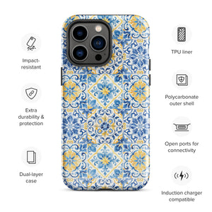 The Blue Mirage for iPhone by Statement Cases features a dual-layered, impact-resistant polycarbonate exterior with a TPU inner liner. Inspired by traditional Portuguese tiles, the blue and yellow patterned case boasts an intricate design of floral and geometric motifs. With its elegant and colorful appearance, the phone's camera is visible at the top left of the case.