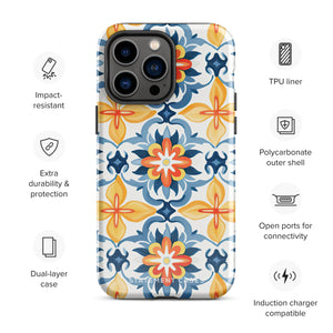 Statement Cases' Mediterranean Bloom for iPhone is showcased, featuring an intricate, colorful pattern. The design includes blue, yellow, and orange floral shapes in a symmetrical arrangement on a light blue background. This durable phone case provides dual-layer protection and is constructed from impact-resistant polycarbonate to safeguard your device.