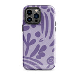 The Luna Morada for iPhone by Statement Cases is a durable phone case with a purple protective exterior featuring abstract dark purple and lavender patterns. The design includes geometric shapes and curves, giving it a modern artistic look. Made from impact-resistant polycarbonate, the lower part of the case prominently displays "STATEMENT CASES.