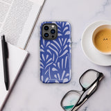 An iPhone encased in the "Mariposa Azul" by Statement Cases, featuring a blue design with an abstract white leaf pattern. The case combines curved and pointed shapes and provides dual-layer protection with TPU lining and impact-resistant polycarbonate. Camera lenses and other top elements remain unobstructed, and "Statement Cases" is inscribed at the bottom.