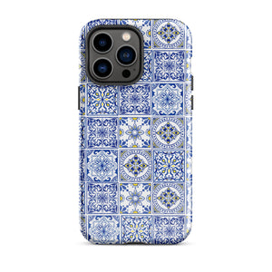 The Lisboa Azul for iPhone by Statement Cases is a smartphone adorned with a dual-layer protection phone case, featuring an intricate blue and white tile pattern. The design showcases various geometric and floral motifs, forming a visually appealing mosaic effect. The impact-resistant camera lenses and flash are prominently visible at the top left.