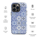 The Lisboa Azul for iPhone by Statement Cases is a smartphone adorned with a dual-layer protection phone case, featuring an intricate blue and white tile pattern. The design showcases various geometric and floral motifs, forming a visually appealing mosaic effect. The impact-resistant camera lenses and flash are prominently visible at the top left.