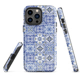 The Lisboa Azul for iPhone by Statement Cases is a smartphone adorned with a dual-layer protection phone case, featuring an intricate blue and white tile pattern. The design showcases various geometric and floral motifs, forming a visually appealing mosaic effect. The impact-resistant camera lenses and flash are prominently visible at the top left.