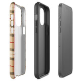 A Neutral Heritage Tartan for iPhone by Statement Cases with a plaid-patterned, impact-resistant polycarbonate case featuring beige, black, white, and red stripes. The durable phone case has the text "STATEMENT CASES" written at the bottom. The phone boasts a triple camera setup with an additional sensor and flash.