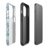 The Blue Mirage for iPhone by Statement Cases features a dual-layered, impact-resistant polycarbonate exterior with a TPU inner liner. Inspired by traditional Portuguese tiles, the blue and yellow patterned case boasts an intricate design of floral and geometric motifs. With its elegant and colorful appearance, the phone's camera is visible at the top left of the case.