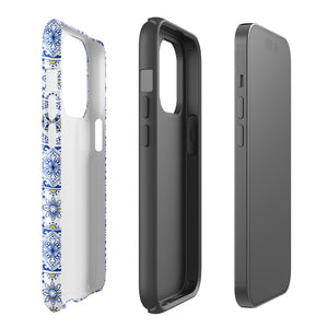 The Lisboa Azul for iPhone by Statement Cases is a smartphone adorned with a dual-layer protection phone case, featuring an intricate blue and white tile pattern. The design showcases various geometric and floral motifs, forming a visually appealing mosaic effect. The impact-resistant camera lenses and flash are prominently visible at the top left.