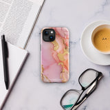 The Gold Blush Marble for iPhone showcases a glossy, marble-patterned case in shades of pink and gold. The decorative design features swirling patterns, seamlessly blending the colors. Crafted with impact-resistant polycarbonate for superior phone protection, "Statement Cases" is written in white at the bottom.