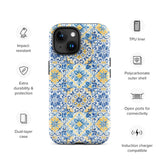 The Blue Mirage for iPhone by Statement Cases features a dual-layered, impact-resistant polycarbonate exterior with a TPU inner liner. Inspired by traditional Portuguese tiles, the blue and yellow patterned case boasts an intricate design of floral and geometric motifs. With its elegant and colorful appearance, the phone's camera is visible at the top left of the case.