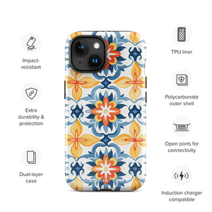 Statement Cases' Mediterranean Bloom for iPhone is showcased, featuring an intricate, colorful pattern. The design includes blue, yellow, and orange floral shapes in a symmetrical arrangement on a light blue background. This durable phone case provides dual-layer protection and is constructed from impact-resistant polycarbonate to safeguard your device.