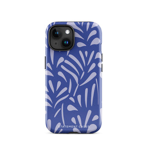 An iPhone encased in the "Mariposa Azul" by Statement Cases, featuring a blue design with an abstract white leaf pattern. The case combines curved and pointed shapes and provides dual-layer protection with TPU lining and impact-resistant polycarbonate. Camera lenses and other top elements remain unobstructed, and "Statement Cases" is inscribed at the bottom.