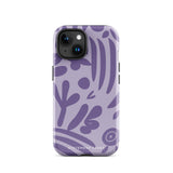 The Luna Morada for iPhone by Statement Cases is a durable phone case with a purple protective exterior featuring abstract dark purple and lavender patterns. The design includes geometric shapes and curves, giving it a modern artistic look. Made from impact-resistant polycarbonate, the lower part of the case prominently displays "STATEMENT CASES.