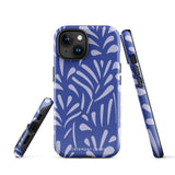 An iPhone encased in the "Mariposa Azul" by Statement Cases, featuring a blue design with an abstract white leaf pattern. The case combines curved and pointed shapes and provides dual-layer protection with TPU lining and impact-resistant polycarbonate. Camera lenses and other top elements remain unobstructed, and "Statement Cases" is inscribed at the bottom.