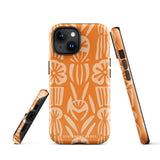 A Savannah Ardiente for iPhone from Statement Cases, featuring a dual-layered phone case in orange with a floral pattern showcasing cream-colored flowers, leaves, and geometric shapes. This impact-resistant polycarbonate case displays "STATEMENT CASES" at the bottom and reveals the camera lenses at the top left corner.