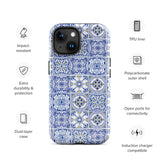 The Lisboa Azul for iPhone by Statement Cases is a smartphone adorned with a dual-layer protection phone case, featuring an intricate blue and white tile pattern. The design showcases various geometric and floral motifs, forming a visually appealing mosaic effect. The impact-resistant camera lenses and flash are prominently visible at the top left.