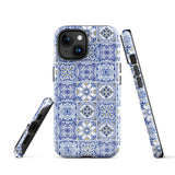 The Lisboa Azul for iPhone by Statement Cases is a smartphone adorned with a dual-layer protection phone case, featuring an intricate blue and white tile pattern. The design showcases various geometric and floral motifs, forming a visually appealing mosaic effect. The impact-resistant camera lenses and flash are prominently visible at the top left.