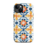 Statement Cases' Mediterranean Bloom for iPhone is showcased, featuring an intricate, colorful pattern. The design includes blue, yellow, and orange floral shapes in a symmetrical arrangement on a light blue background. This durable phone case provides dual-layer protection and is constructed from impact-resistant polycarbonate to safeguard your device.