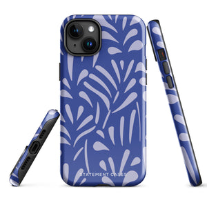 An iPhone encased in the "Mariposa Azul" by Statement Cases, featuring a blue design with an abstract white leaf pattern. The case combines curved and pointed shapes and provides dual-layer protection with TPU lining and impact-resistant polycarbonate. Camera lenses and other top elements remain unobstructed, and "Statement Cases" is inscribed at the bottom.