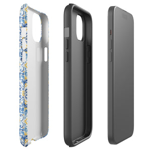 The Blue Mirage for iPhone by Statement Cases features a dual-layered, impact-resistant polycarbonate exterior with a TPU inner liner. Inspired by traditional Portuguese tiles, the blue and yellow patterned case boasts an intricate design of floral and geometric motifs. With its elegant and colorful appearance, the phone's camera is visible at the top left of the case.