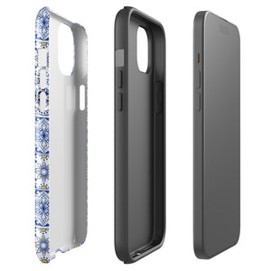 The Lisboa Azul for iPhone by Statement Cases is a smartphone adorned with a dual-layer protection phone case, featuring an intricate blue and white tile pattern. The design showcases various geometric and floral motifs, forming a visually appealing mosaic effect. The impact-resistant camera lenses and flash are prominently visible at the top left.