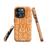 A Savannah Ardiente for iPhone from Statement Cases, featuring a dual-layered phone case in orange with a floral pattern showcasing cream-colored flowers, leaves, and geometric shapes. This impact-resistant polycarbonate case displays "STATEMENT CASES" at the bottom and reveals the camera lenses at the top left corner.