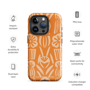 A Savannah Ardiente for iPhone from Statement Cases, featuring a dual-layered phone case in orange with a floral pattern showcasing cream-colored flowers, leaves, and geometric shapes. This impact-resistant polycarbonate case displays "STATEMENT CASES" at the bottom and reveals the camera lenses at the top left corner.