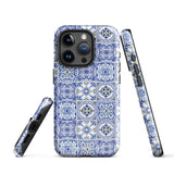 The Lisboa Azul for iPhone by Statement Cases is a smartphone adorned with a dual-layer protection phone case, featuring an intricate blue and white tile pattern. The design showcases various geometric and floral motifs, forming a visually appealing mosaic effect. The impact-resistant camera lenses and flash are prominently visible at the top left.