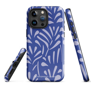 An iPhone encased in the "Mariposa Azul" by Statement Cases, featuring a blue design with an abstract white leaf pattern. The case combines curved and pointed shapes and provides dual-layer protection with TPU lining and impact-resistant polycarbonate. Camera lenses and other top elements remain unobstructed, and "Statement Cases" is inscribed at the bottom.