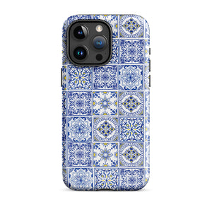 The Lisboa Azul for iPhone by Statement Cases is a smartphone adorned with a dual-layer protection phone case, featuring an intricate blue and white tile pattern. The design showcases various geometric and floral motifs, forming a visually appealing mosaic effect. The impact-resistant camera lenses and flash are prominently visible at the top left.