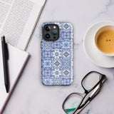 The Lisboa Azul for iPhone by Statement Cases is a smartphone adorned with a dual-layer protection phone case, featuring an intricate blue and white tile pattern. The design showcases various geometric and floral motifs, forming a visually appealing mosaic effect. The impact-resistant camera lenses and flash are prominently visible at the top left.