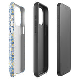 The Blue Mirage for iPhone by Statement Cases features a dual-layered, impact-resistant polycarbonate exterior with a TPU inner liner. Inspired by traditional Portuguese tiles, the blue and yellow patterned case boasts an intricate design of floral and geometric motifs. With its elegant and colorful appearance, the phone's camera is visible at the top left of the case.