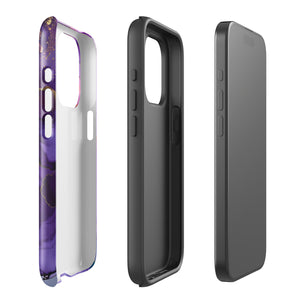 A Statement Cases Golden Orchid Marble for iPhone with a case featuring an abstract design of swirling purple, pink, and gold hues over a white background. The marbled patterns with metallic accents provide dual-layer protection and are impact-resistant. The top of the case has cutouts for the phone's camera lenses and is induction charging compatible.