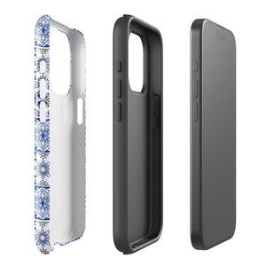 The Lisboa Azul for iPhone by Statement Cases is a smartphone adorned with a dual-layer protection phone case, featuring an intricate blue and white tile pattern. The design showcases various geometric and floral motifs, forming a visually appealing mosaic effect. The impact-resistant camera lenses and flash are prominently visible at the top left.