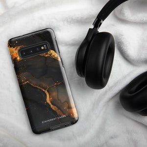 A **Midnight Volcano Marble for Samsung** with a sleek, black and gold marble-patterned, dual-layer design case by **Statement Cases**. The impact-resistant case features fluid, abstract swirls of black and gold, creating an elegant look. The camera module at the top left has five lenses.