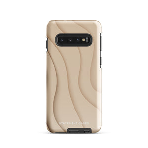 A Sandy Serenity for Samsung encased in a beige, impact-resistant phone case with wavy, textured patterns. Four camera lenses are visible on the back. The lower part of the dual-layer design case displays the text "Statement Cases.