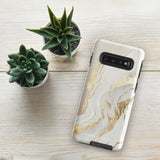 A Golden Elegance for Samsung is encased in a decorative, impact-resistant phone case with a marble-like design featuring white, beige, and gold swirls. The tough phone case covers the back and sides, with precise cutouts for the four-lens camera and buttons. The brand "Statement Cases" is printed at the bottom.