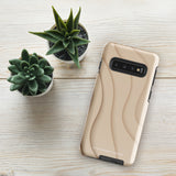 A Sandy Serenity for Samsung encased in a beige, impact-resistant phone case with wavy, textured patterns. Four camera lenses are visible on the back. The lower part of the dual-layer design case displays the text "Statement Cases.