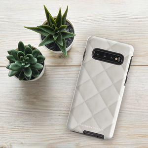 A Quilted Delight for Samsung with a quilted pattern in a light cream color made from impact-resistant materials. The case has a cutout for the camera module with four lenses and a flash. "Statement Cases" is branded at the bottom in white text.