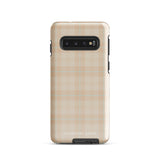 A smartphone with an impact-resistant beige plaid phone case featuring subtle light blue accents. The camera, flash, and sensor modules are visible at the top. The bottom part of the case has the text "Sophisticated Plaid for Samsung" printed on it by Statement Cases.