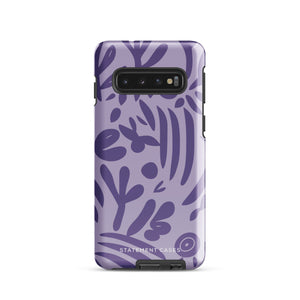 Introducing the Luna Morada for Samsung, a striking smartphone case from Statement Cases. This decorative purple cover boasts abstract floral and organic patterns in darker hues and is designed to absorb shocks. The impact-resistant case features a camera cutout that accommodates five lenses, with the brand name "STATEMENT CASES" elegantly printed at the bottom center.