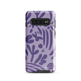 Introducing the Luna Morada for Samsung, a striking smartphone case from Statement Cases. This decorative purple cover boasts abstract floral and organic patterns in darker hues and is designed to absorb shocks. The impact-resistant case features a camera cutout that accommodates five lenses, with the brand name "STATEMENT CASES" elegantly printed at the bottom center.