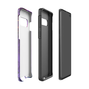 The Golden Orchid Marble for Samsung by Statement Cases is a smartphone adorned with a vibrant, abstract phone case showcasing a mix of purple, pink, and gold colors. Crafted from impact-resistant materials, it features a camera module with four lenses and a flash. At the bottom of the shock-absorbing phone case, you’ll find the text "STATEMENT CASES" in white.