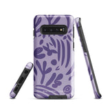 Introducing the Luna Morada for Samsung, a striking smartphone case from Statement Cases. This decorative purple cover boasts abstract floral and organic patterns in darker hues and is designed to absorb shocks. The impact-resistant case features a camera cutout that accommodates five lenses, with the brand name "STATEMENT CASES" elegantly printed at the bottom center.