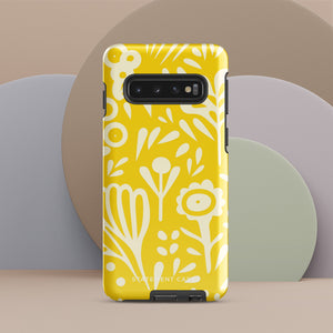 The Sol Dorado for Samsung by Statement Cases is a durable phone case featuring a bright yellow background adorned with an abstract white floral pattern, showcasing various flowers and leaves. Near the bottom edge, the text "STATEMENT CASE" highlights its dual-layer design for enhanced durability.