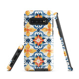 The Mediterranean Bloom for Samsung by Statement Cases features intricate, colorful floral patterns in blue, orange, and yellow. The design covers the entire back of the case, surrounding the camera cutout. Shock-absorbing and impact-resistant, it ensures protection while the brand "Statement Cases" is subtly printed near the bottom.